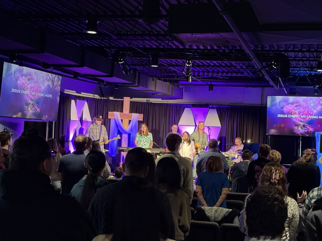 A Sunday service at Anchor Point, with the worship band on stage and the congregation singing.